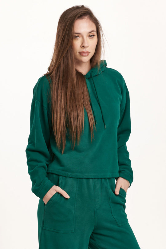 image of a female model wearing a PAXTON HOODIE SWEATSHIRT DEEP EMERALD DEAR JOHN DENIM 