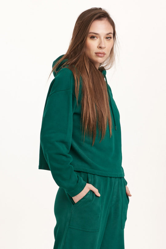 image of a female model wearing a PAXTON HOODIE SWEATSHIRT DEEP EMERALD DEAR JOHN DENIM 