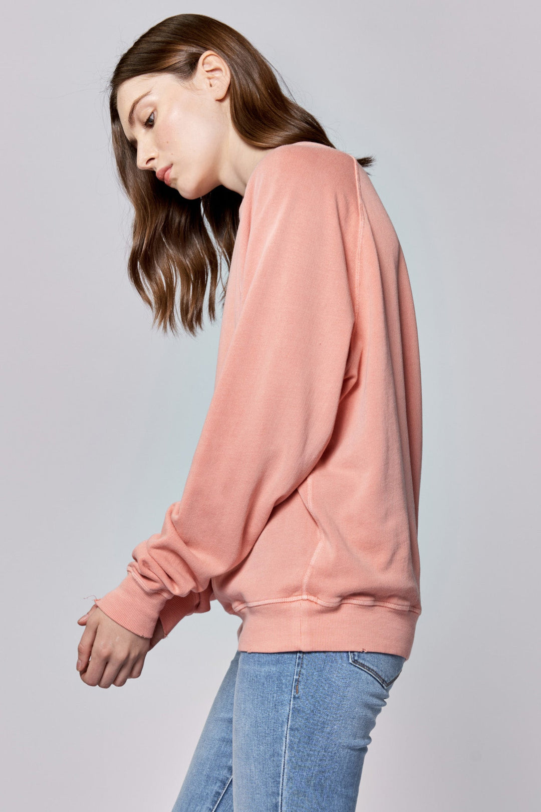 image of a female model wearing a LILJA RAGLAN SLEEVE RELAXED FIT SWEATER TERRACOTTA DEAR JOHN DENIM 