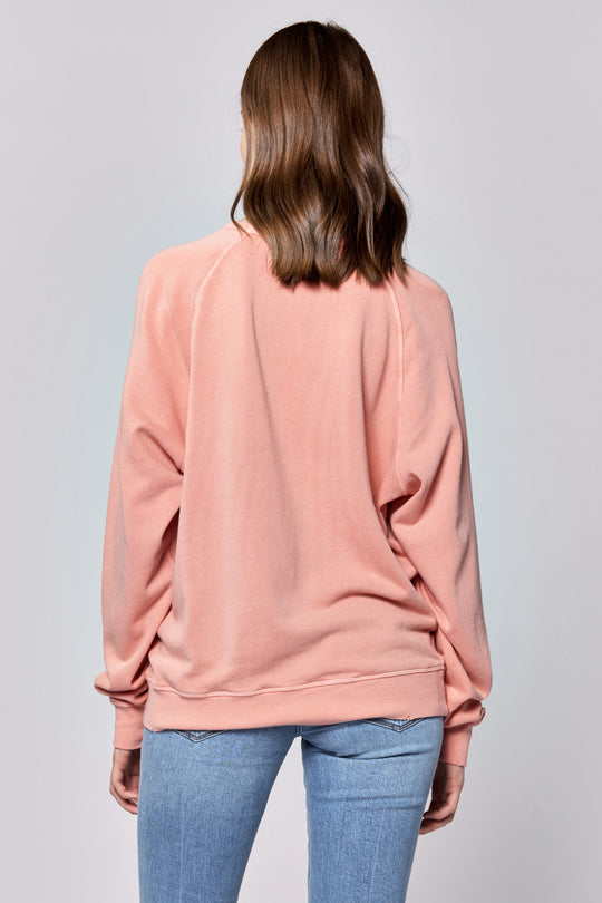 image of a female model wearing a LILJA RAGLAN SLEEVE RELAXED FIT SWEATER TERRACOTTA DEAR JOHN DENIM 