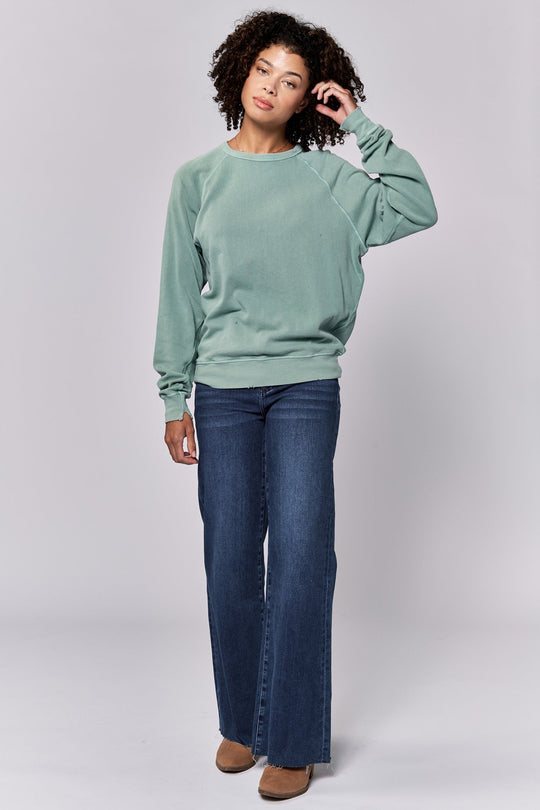 image of a female model wearing a LILJA RAGLAN SLEEVE RELAXED FIT SWEATER ICEBERG GREEN DEAR JOHN DENIM 