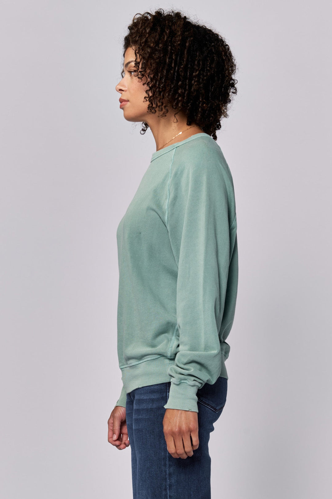 image of a female model wearing a LILJA RAGLAN SLEEVE RELAXED FIT SWEATER ICEBERG GREEN DEAR JOHN DENIM 