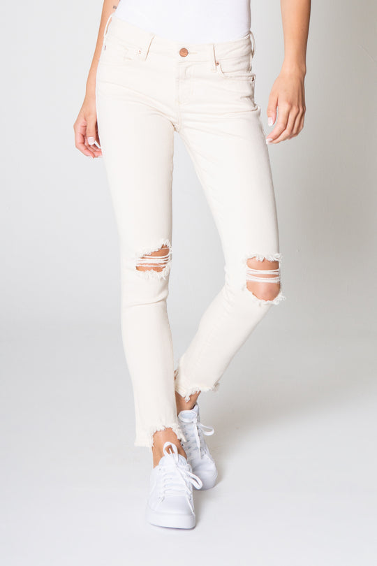 image of a female model wearing a 8 1/2" MID RISE JOYRICH SKINNY WHEAT JEANS