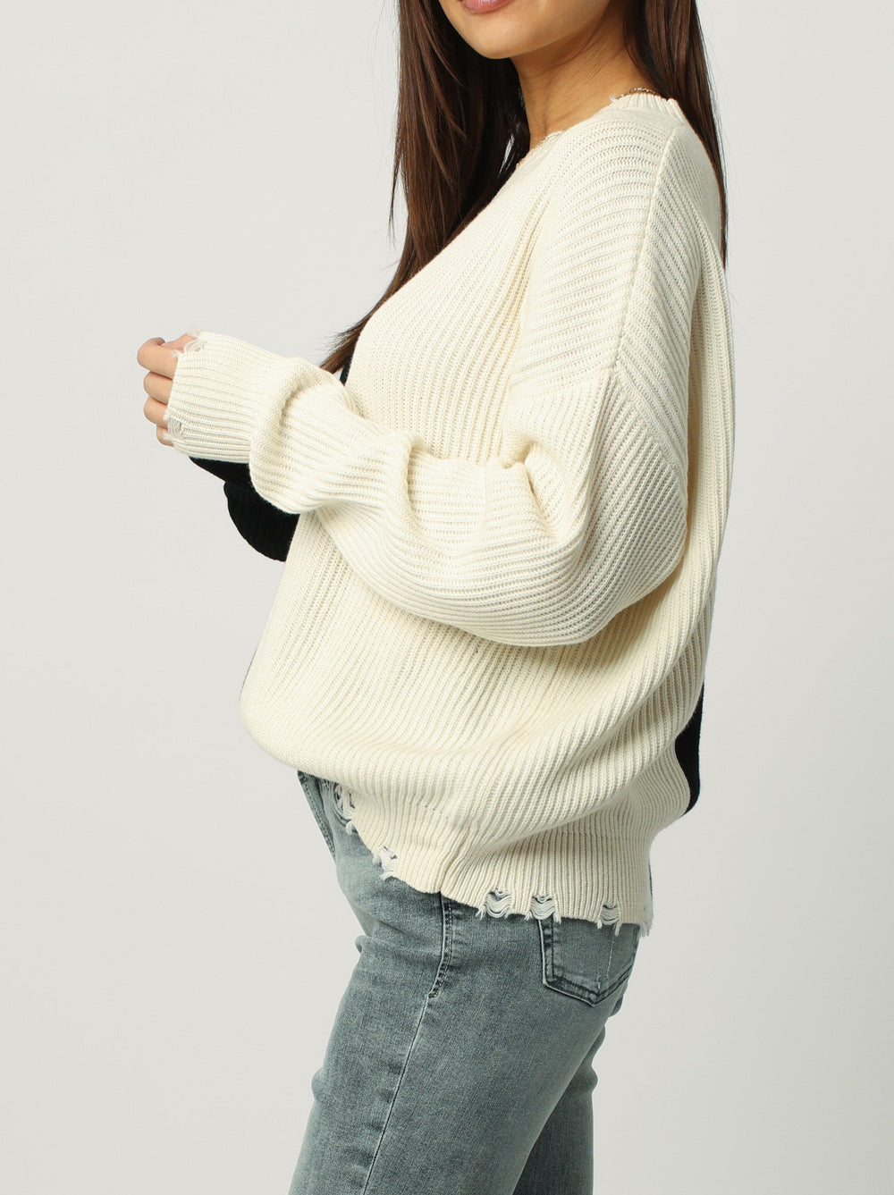 image of a female model wearing a SYDNEY COLOR BLOCK SWEATER BLACK CREAM DEAR JOHN DENIM 