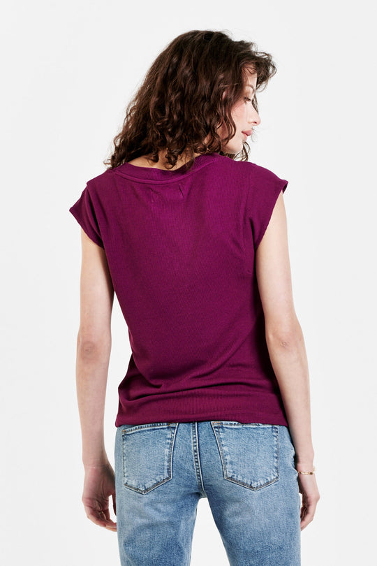 image of a female model wearing a URI THERMAL V-NECK TOP PURPLE POTION TOPS