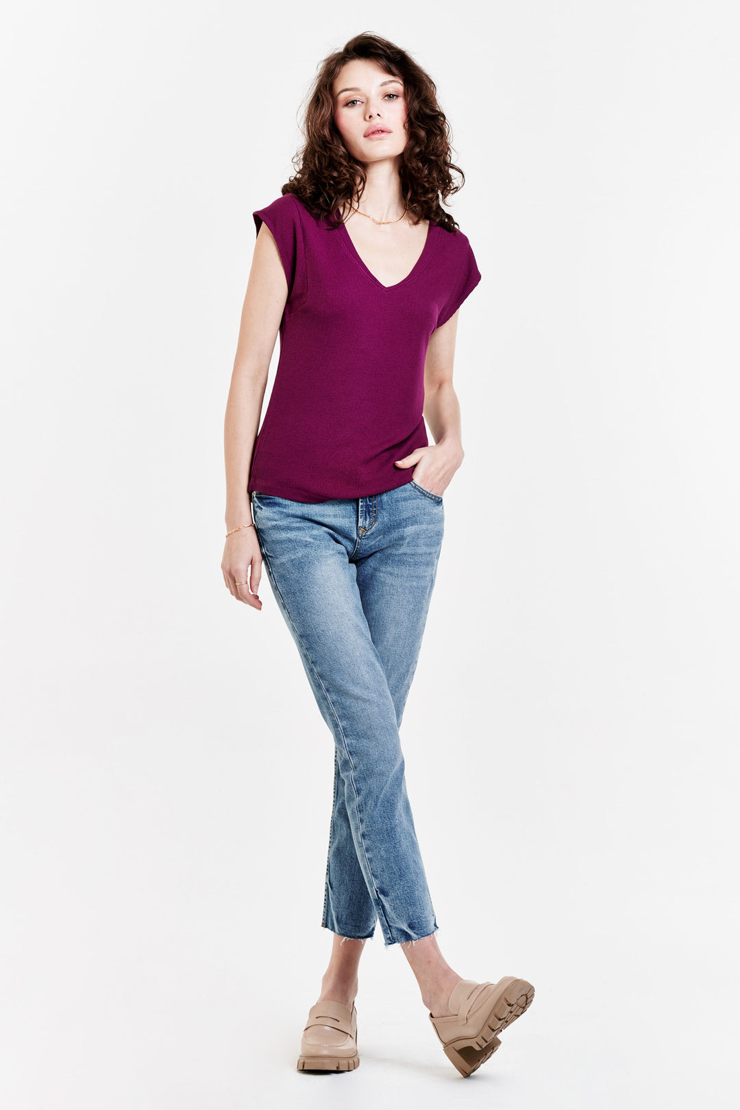 image of a female model wearing a URI THERMAL V-NECK TOP PURPLE POTION TOPS