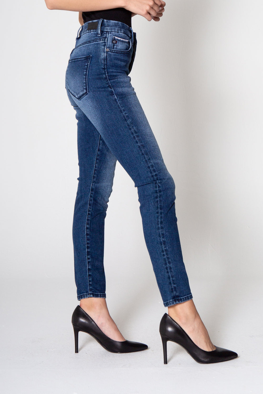 image of a female model wearing a OLIVIA SUPER HIGH RISE ANKLE SKINNY JEANS COLVILLE JEANS