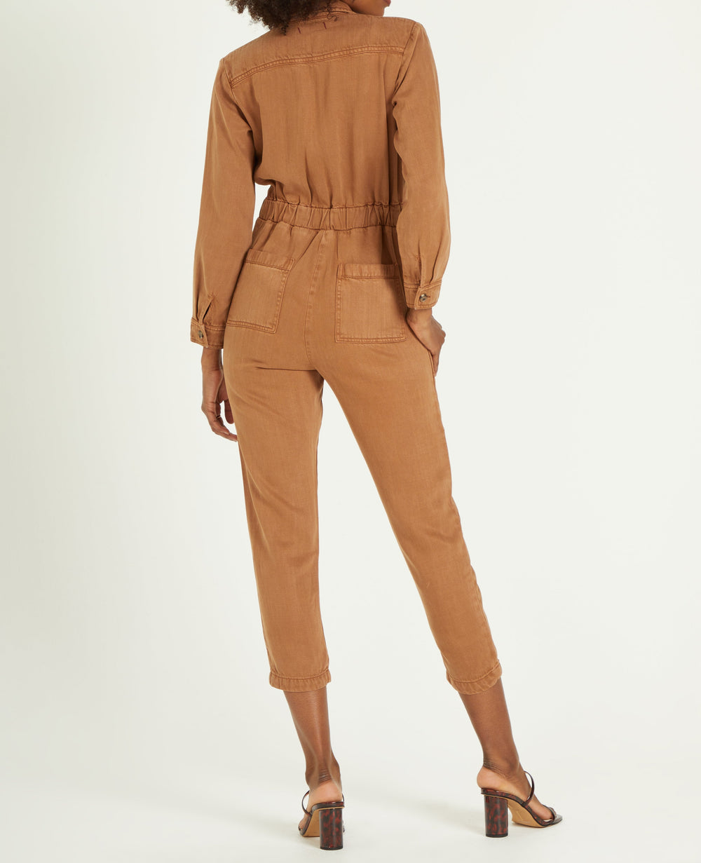 image of a female model wearing a FERGIE JUMPSUIT IN DARK TAN DEAR JOHN DENIM 