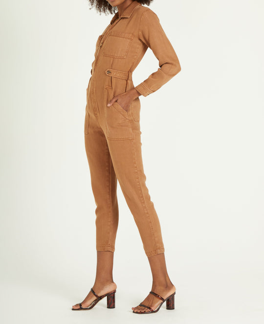 image of a female model wearing a FERGIE JUMPSUIT IN DARK TAN DEAR JOHN DENIM 