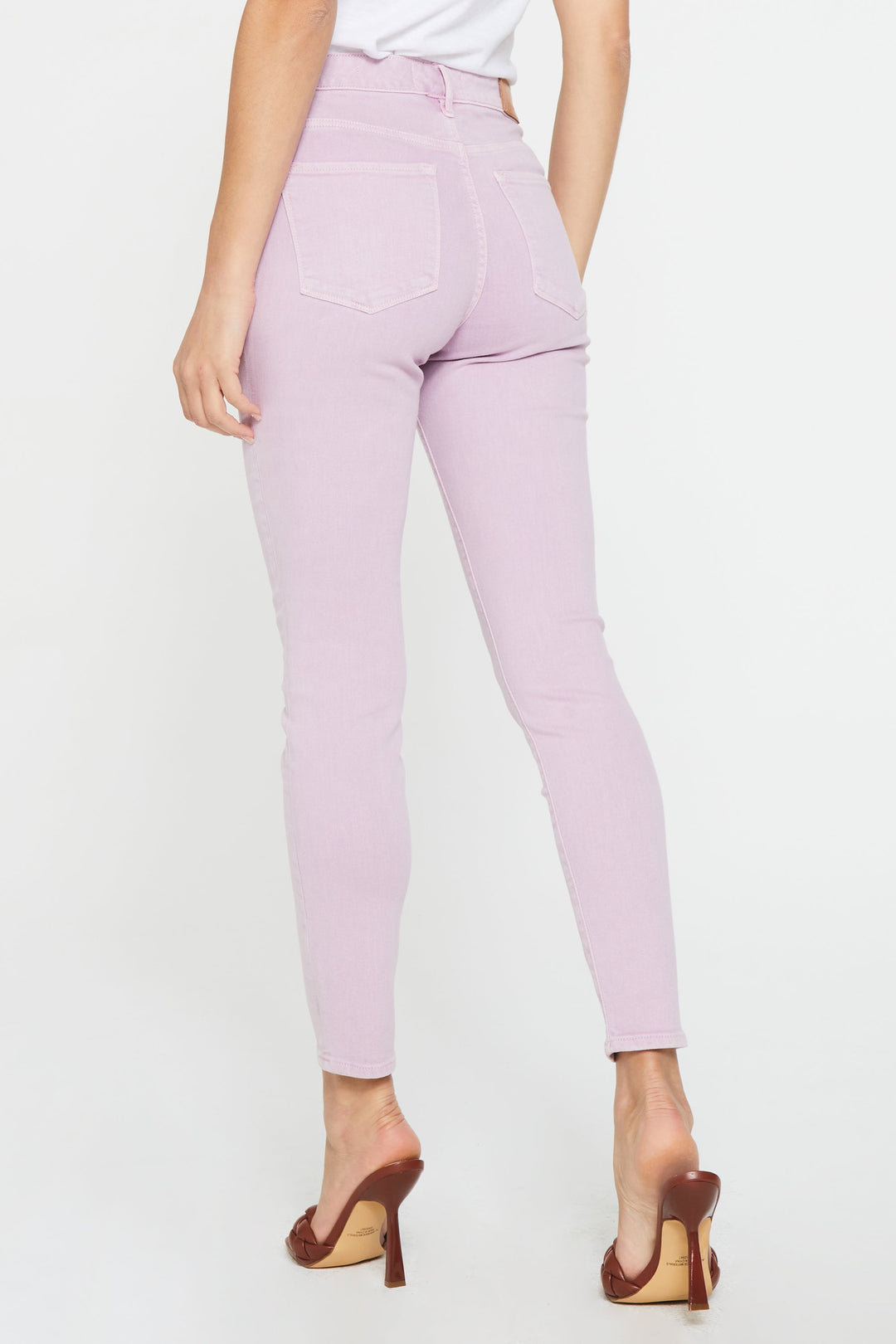 image of a female model wearing a GISELE HIGH RISE ANKLE SKINNY JEANS LAVENDER PINK JEANS