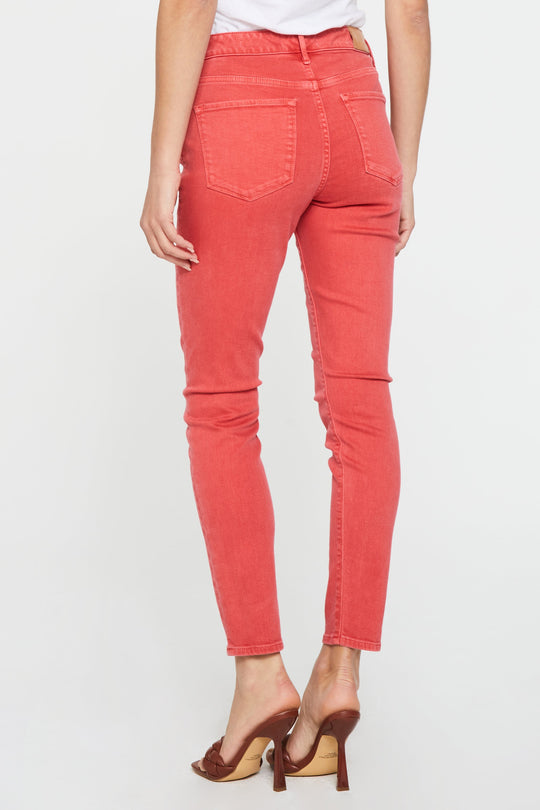 image of a female model wearing a GISELE HIGH RISE ANKLE SKINNY JEANS SCARLET JEANS