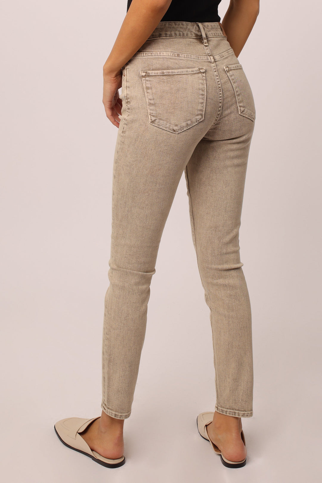 image of a female model wearing a GISELE HIGH RISE ANKLE SKINNY JEANS BISCOTTI JEANS