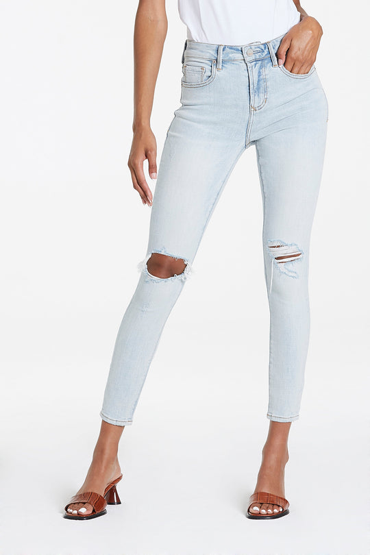 image of a female model wearing a OLIVIA SUPER HIGH RISE ANKLE SKINNY JEANS BLUE WATER JEANS
