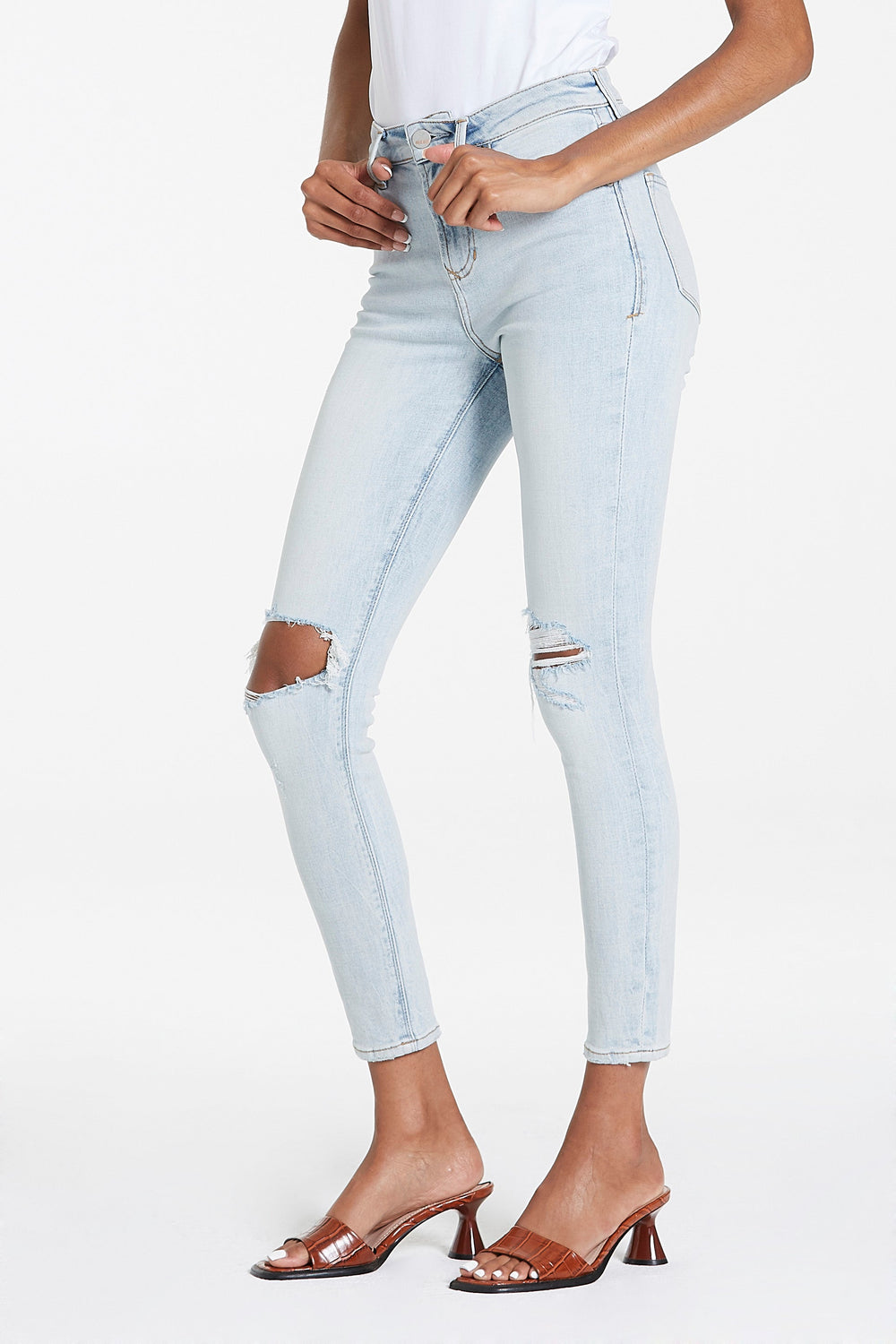 image of a female model wearing a OLIVIA SUPER HIGH RISE ANKLE SKINNY JEANS BLUE WATER JEANS