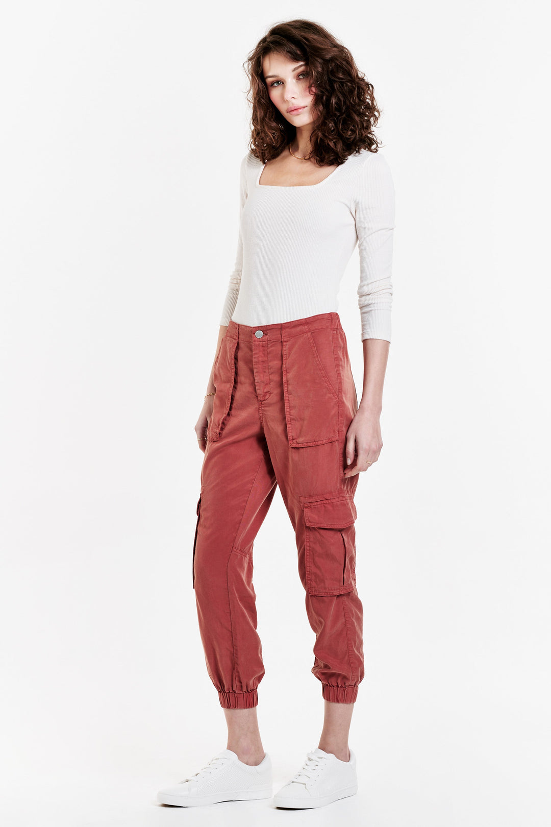 image of a female model wearing a SANDY SUPER HIGH RISE ANKLE TROUSER PANTS POTTERS CLAY PANTS