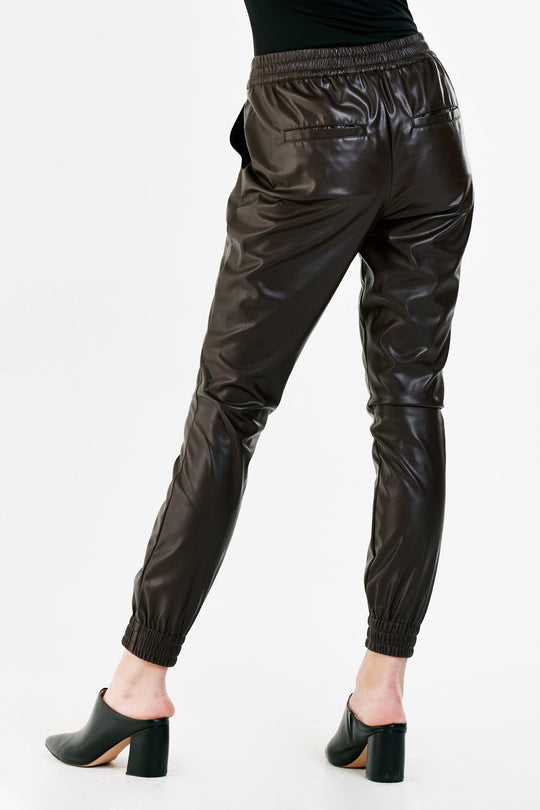 image of a female model wearing a JACEY SUPER HIGHRISE CROPPED JOGGER PANTS COFFEE VEGAN LEATHER DEAR JOHN DENIM 