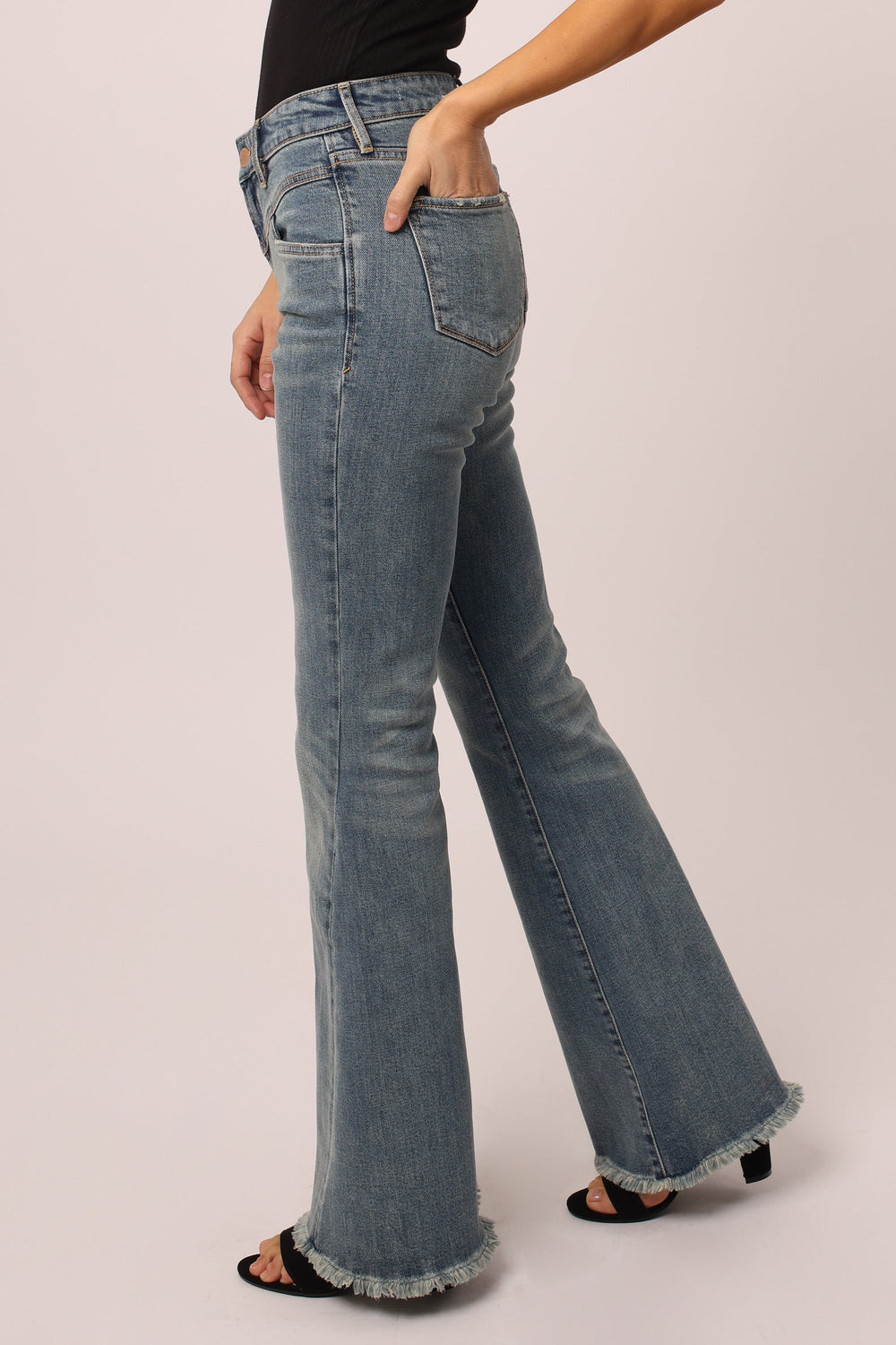 image of a female model wearing a ROSA HIGH RISE FLARE JEANS STOKES CANYON DEAR JOHN DENIM 
