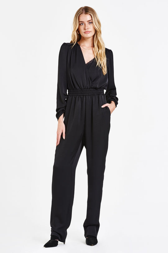image of a female model wearing a BROOKE SILKY WRAP ROMPER IRON JUMPSUITS
