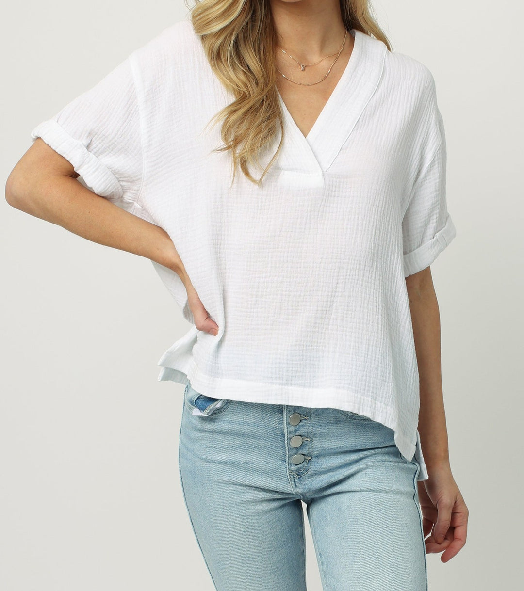 image of a female model wearing a JAILEE SHORT SLEEVE V NECK TOP WHITE WHITE TOPS