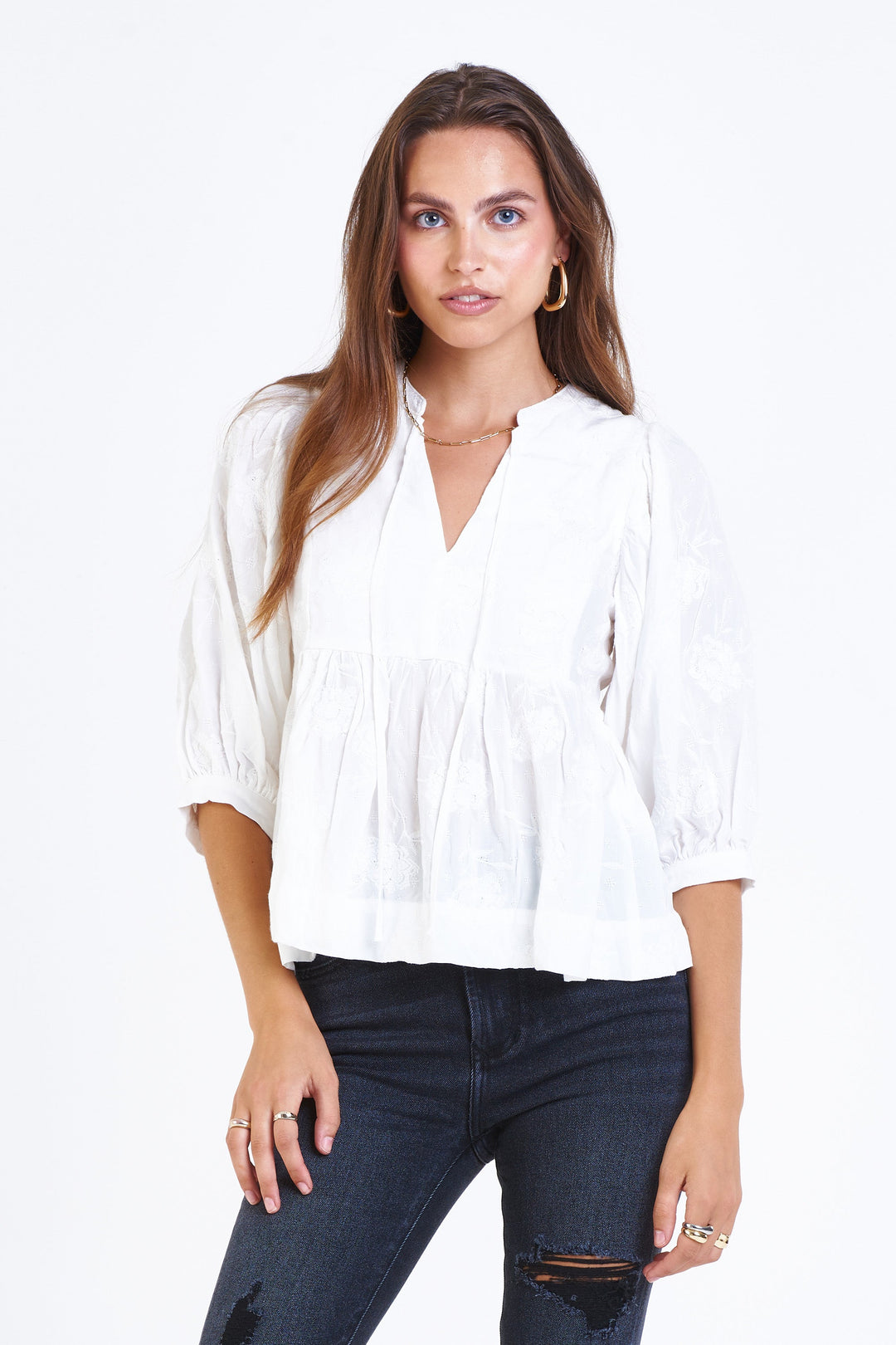 image of a female model wearing a MALIA V-NECK TOP PEARLED IVORY FLORAL TOPS
