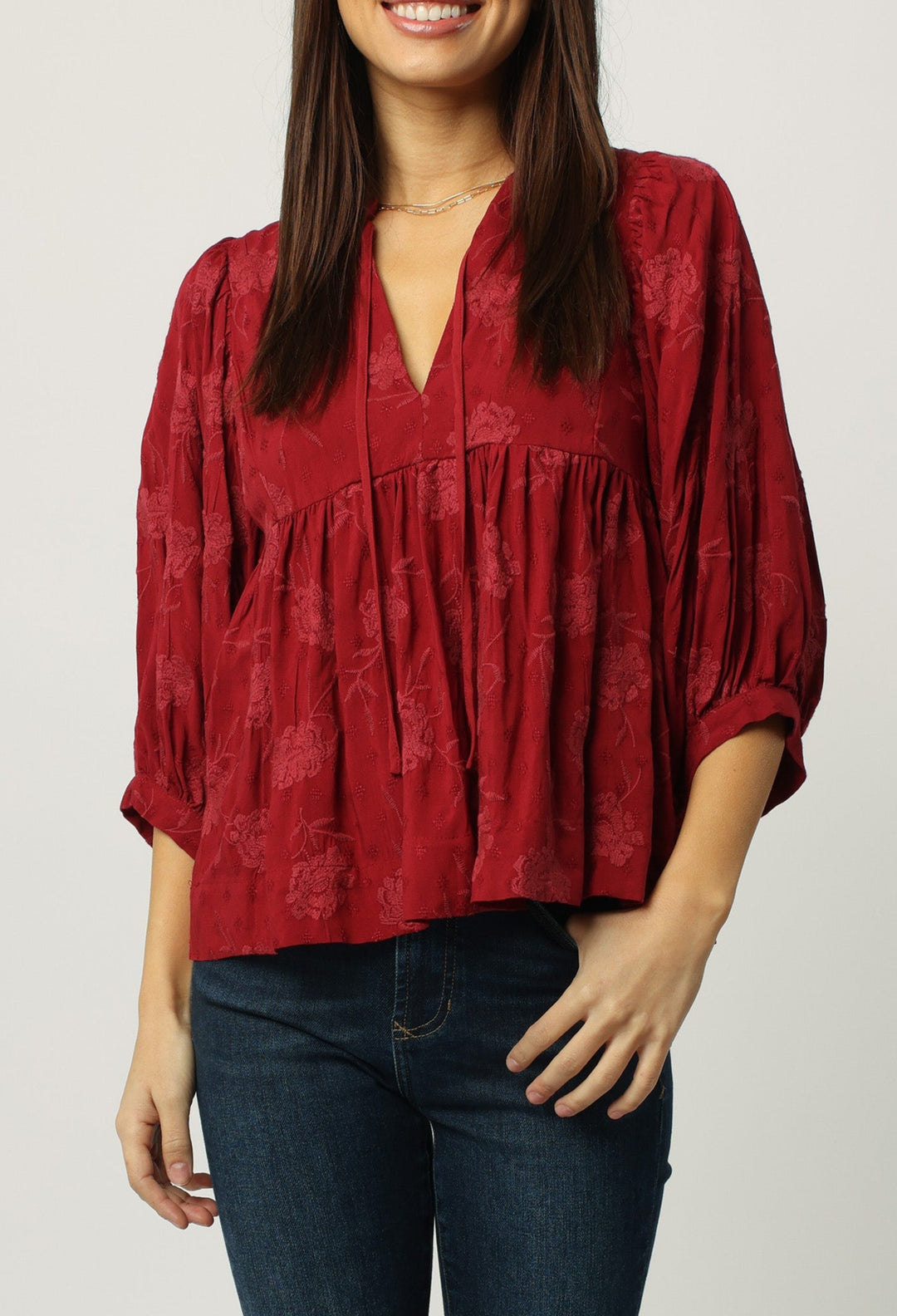 image of a female model wearing a MALIA 3/4 LONG SLEEVE V-NECK TOP RED DAHLIA TOPS