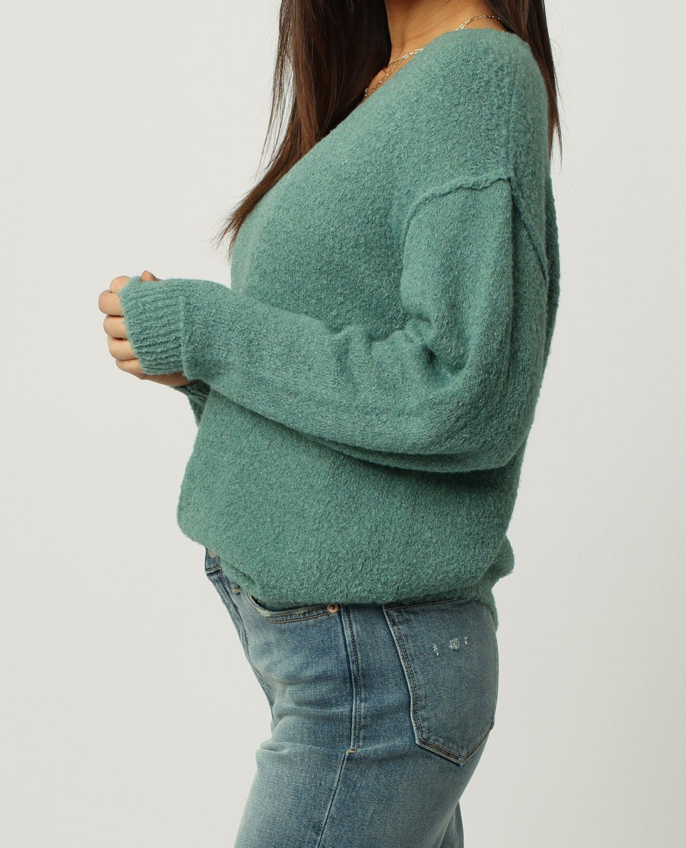 image of a female model wearing a CALLEEN V-NECK LONG SLEEVE SWEATER EMERALD STONE DEAR JOHN DENIM 