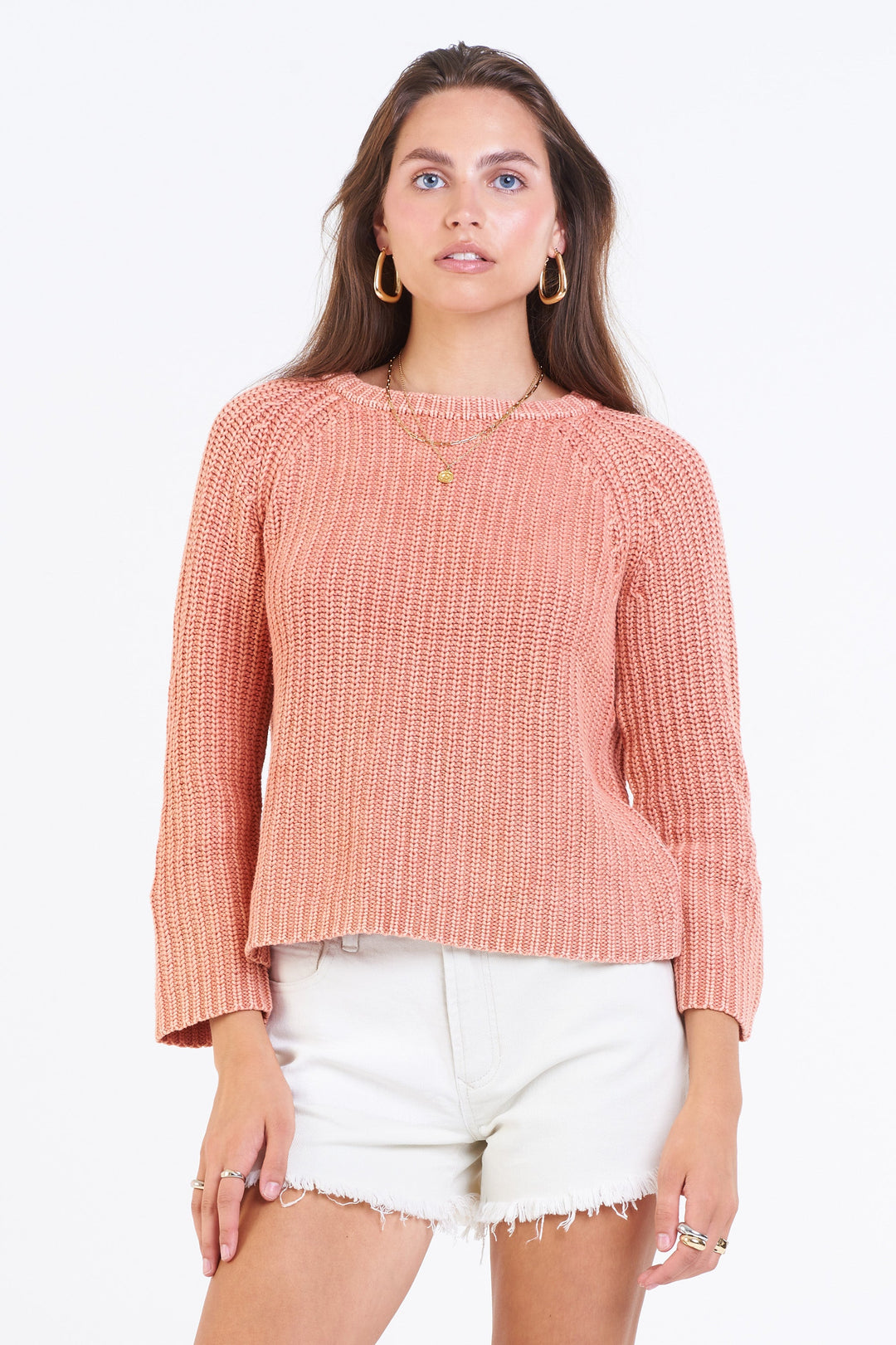 image of a female model wearing a ODETTE RAGLAN SWEATER CORAL SANDS SWEATERS