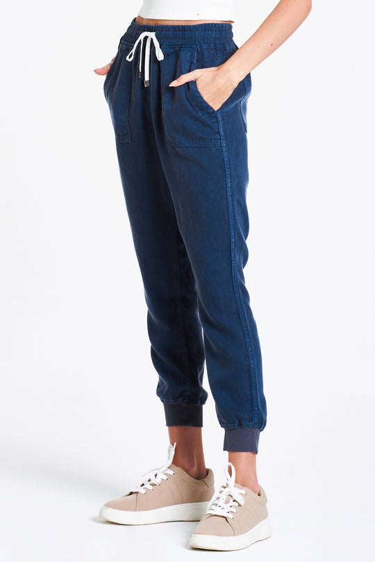 image of a female model wearing a JACEY SUPER HIGH RISE CROPPED JOGGER PANTS BLUE OPAL DEAR JOHN DENIM 