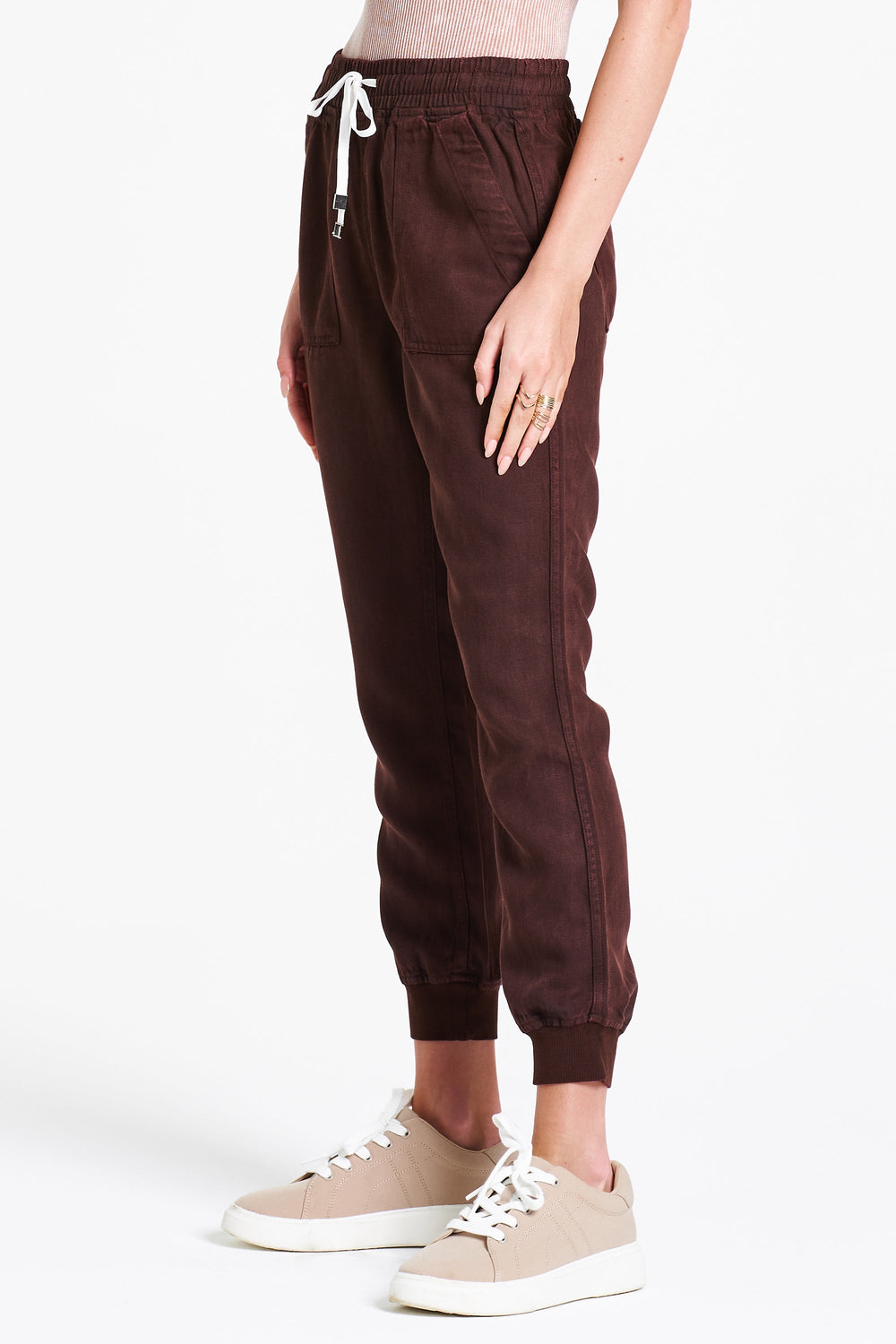 image of a female model wearing a JACEY SUPER HIGH RISE CROPPED JOGGER PANTS DARK OAK DEAR JOHN DENIM 