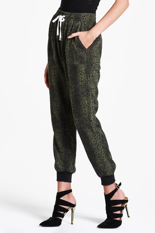 image of a female model wearing a JACEY SUPER HIGH RISE CROPPED JOGGER PANTS GREEN CHEETAH PANTS