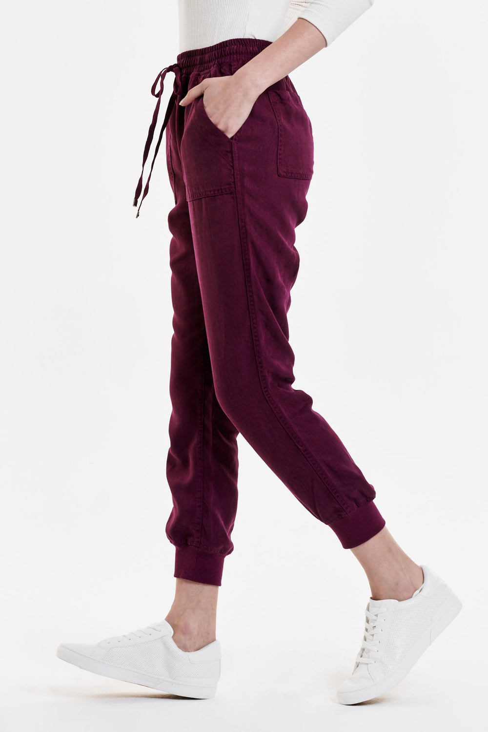 image of a female model wearing a JACEY SUPER HIGH RISE CROPPED JOGGER PANTS PURPLE POTION PANTS
