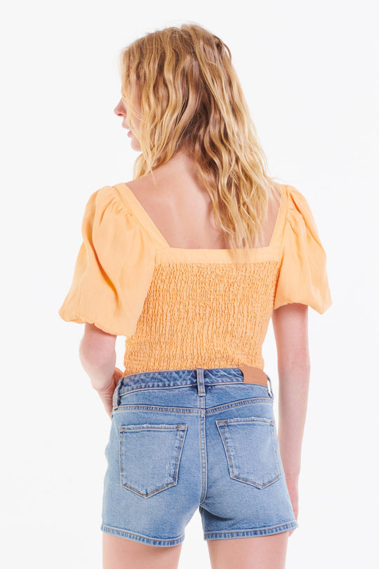 image of a female model wearing a PEIGHTON PUFF SLEEVE TOP CREAMSICLE TOPS