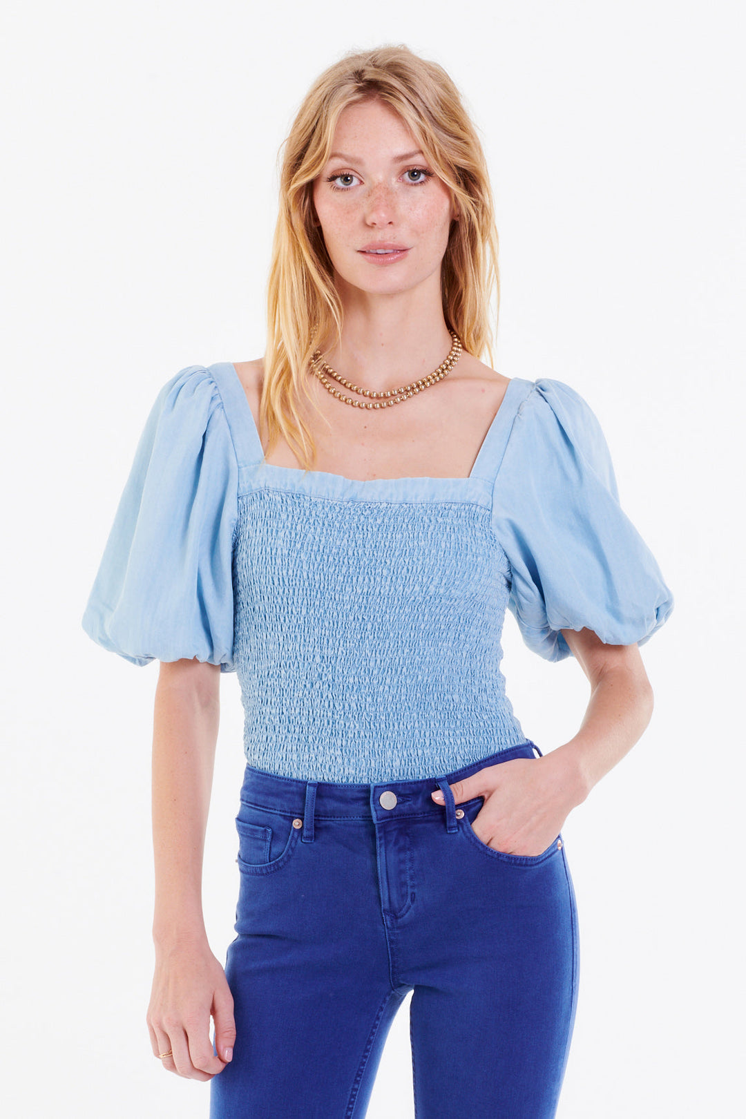 image of a female model wearing a PEIGHTON PUFF SLEEVE TOP PERFECT BLUE TOPS