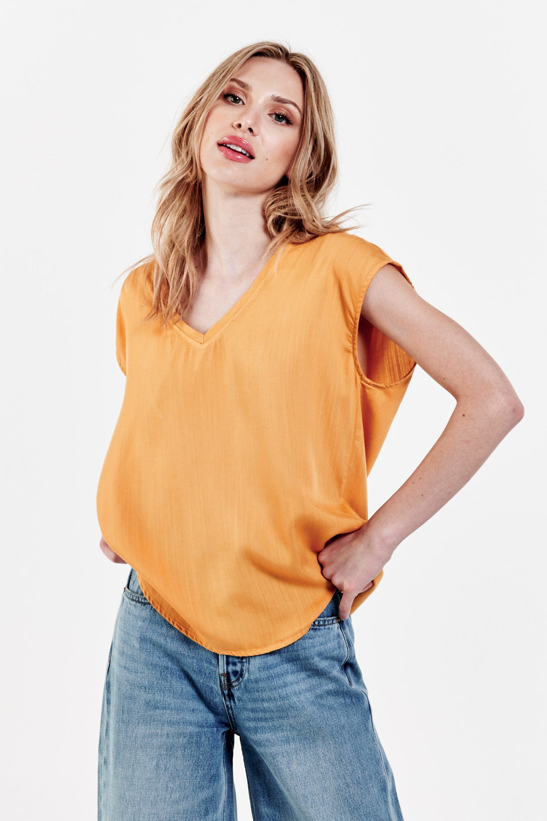 image of a female model wearing a YANIS SLEEVELESS TOP GOLDEN GLOW TOPS