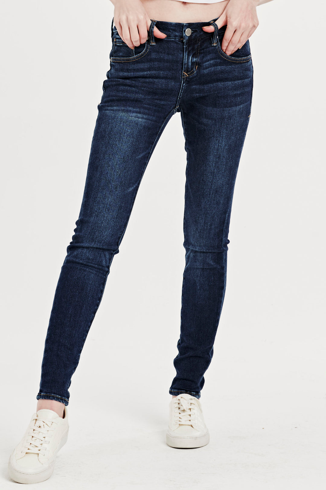 image of a female model wearing a joyrich mid rise skinny jeans mullholland JEANS