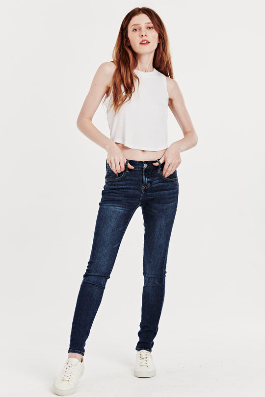 image of a female model wearing a joyrich mid rise skinny jeans mullholland JEANS